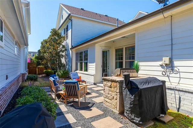 a view of backyard with seating space and wooden deck