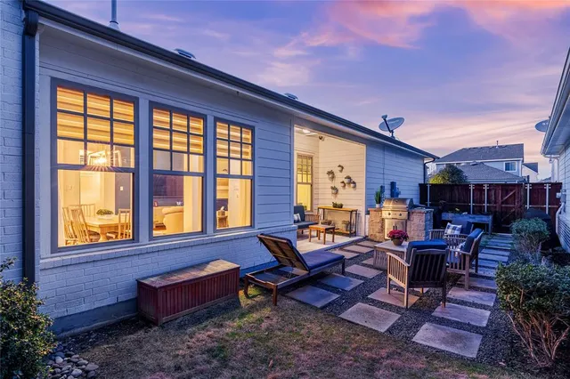 a living room filled with furniture and a potted plant