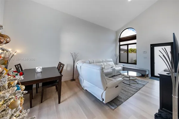 a living room with furniture and a wooden floor