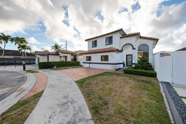 a front view of a house with a yard
