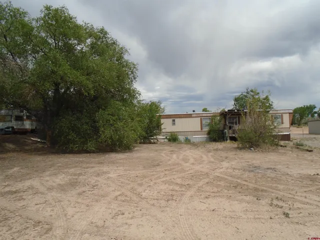 a pathway of a house with a yard