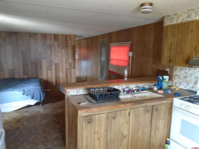 a kitchen with a sink stove and cabinets