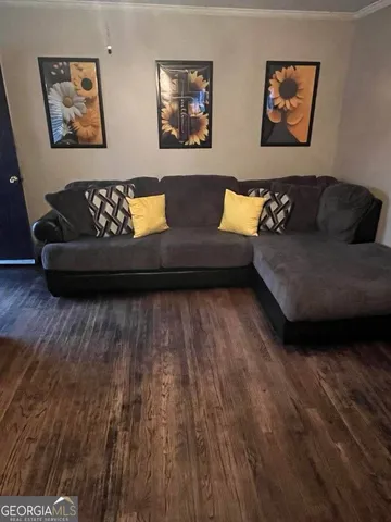 a living room with furniture and painting on the wall