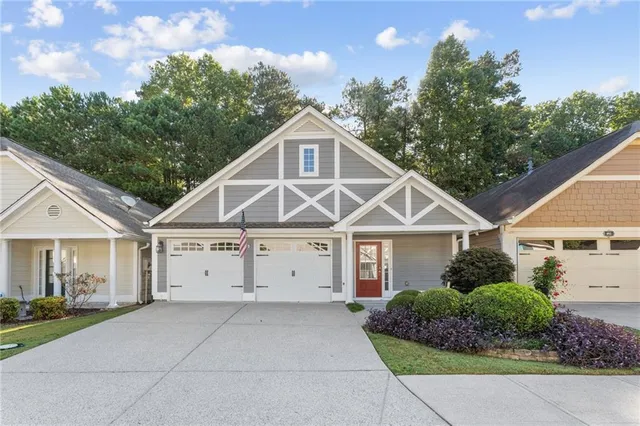 a front view of a house with a garden