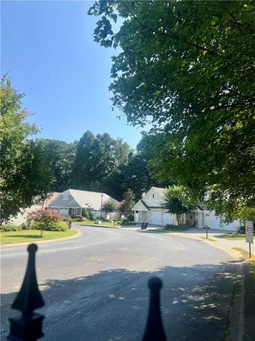 a view of swimming pool with seating area and trees in the background
