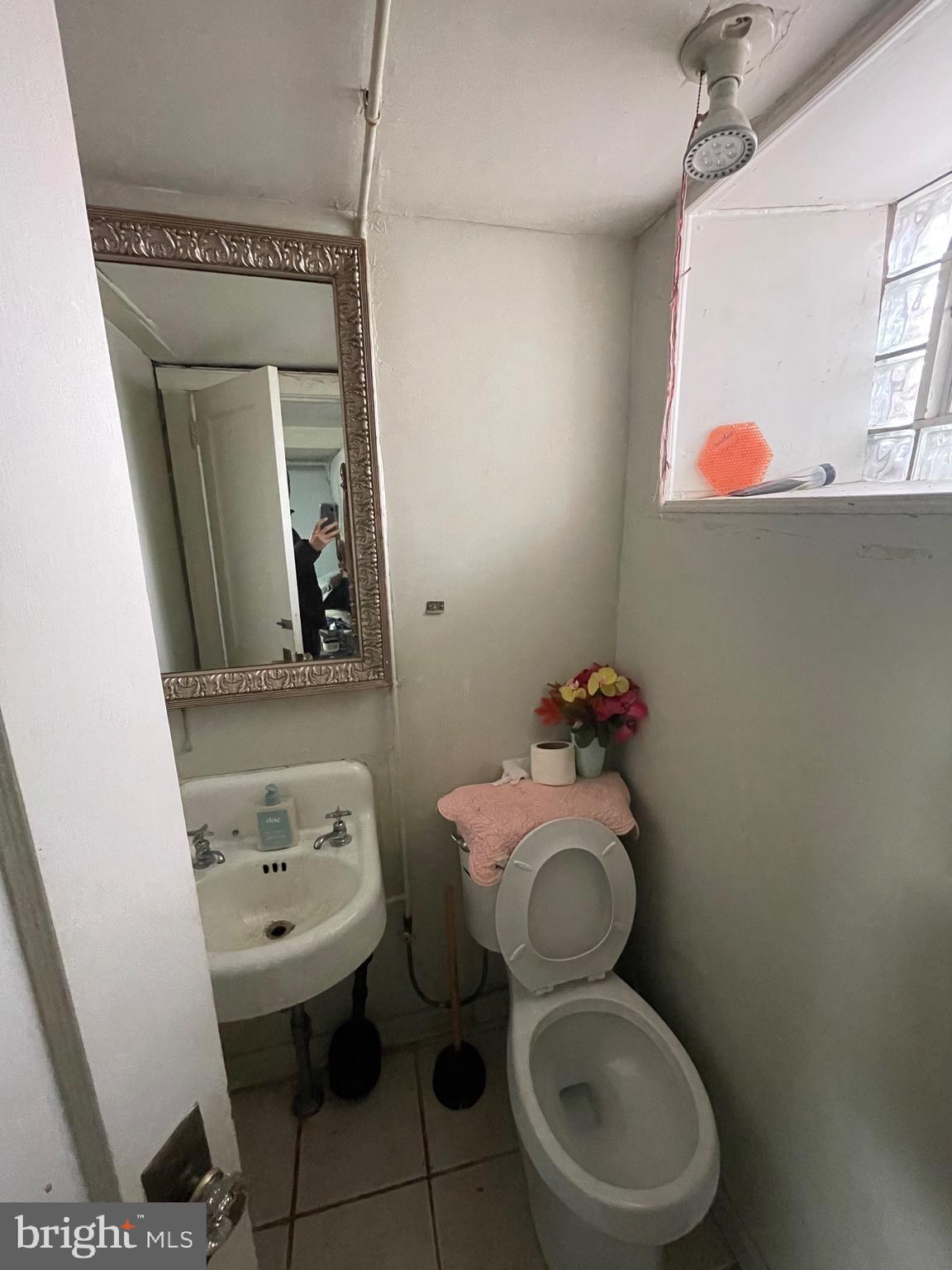 1141 Gilham Street Philadelphia, PA 19111 - Photo 14 of 16 a bathroom with a toilet sink and mirror