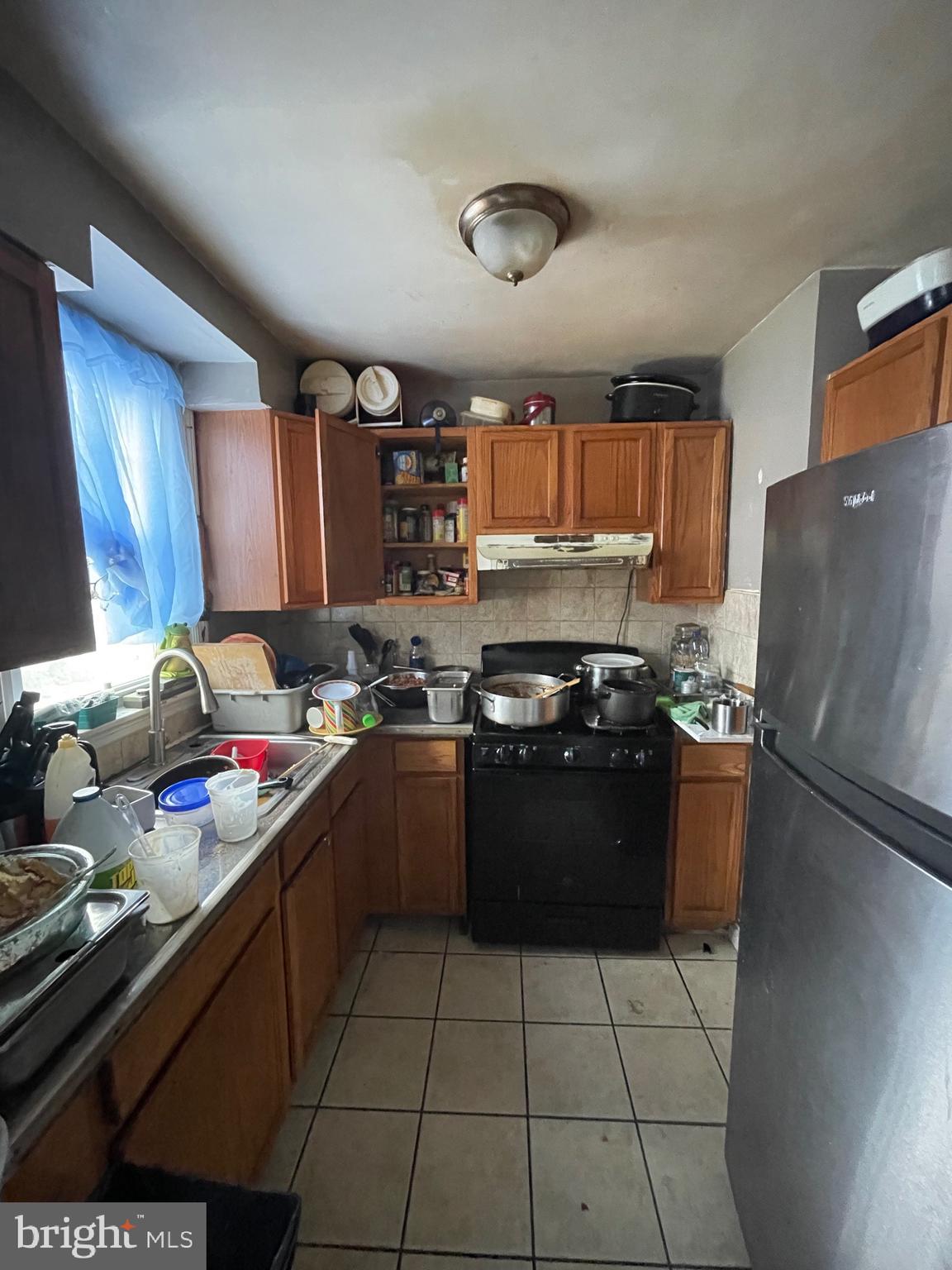 1141 Gilham Street Philadelphia, PA 19111 - Photo 4 of 16 a kitchen with stainless steel appliances granite countertop a sink stove and refrigerator