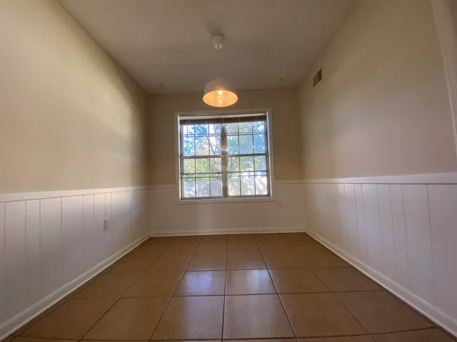 a view of a room with a fan and a window