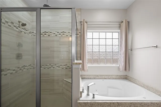 a bathroom with a bathtub and a shower