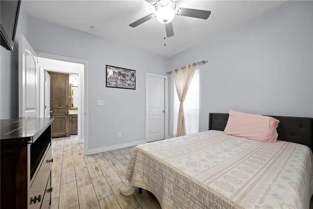 a bedroom with a large bed and a chandelier