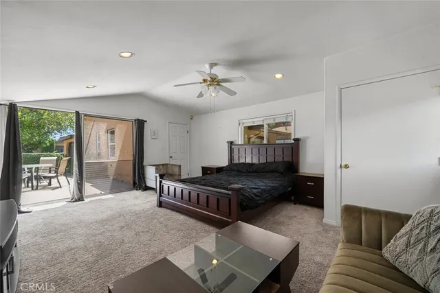 a view of a patio with a table and chairs under an umbrella