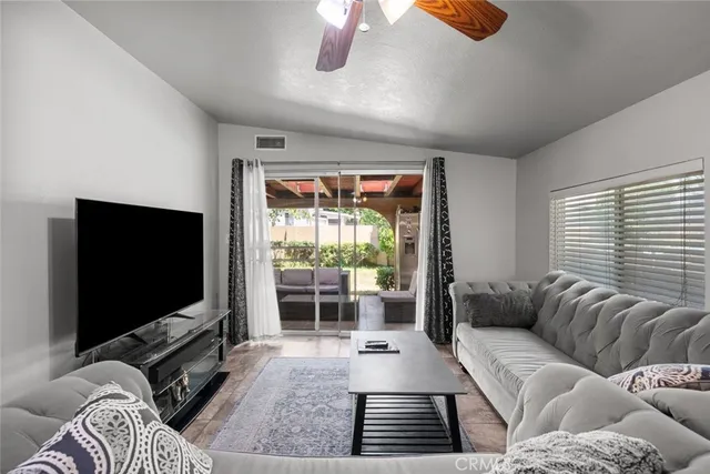 a front view of house with yard and trees in the background