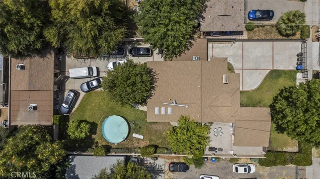 an aerial view of a house with garden space and swimming pool