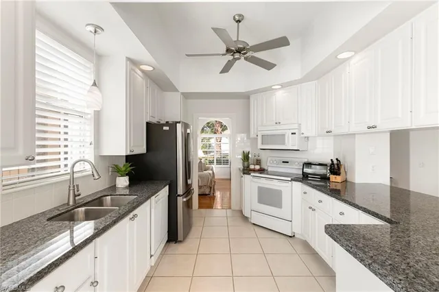 a kitchen with a sink appliances and cabinets