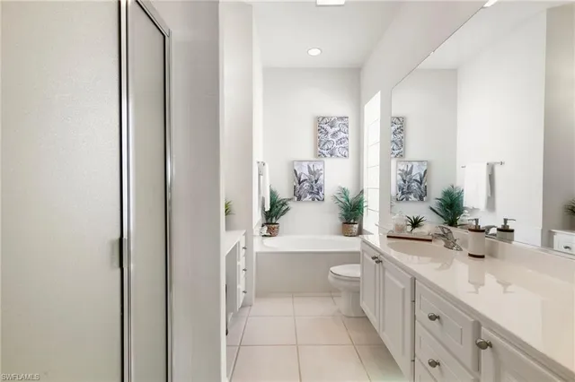 a bathroom with a sink a large mirror and a bathtub