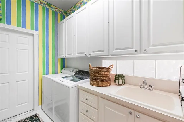 a kitchen with a sink cabinets and appliances