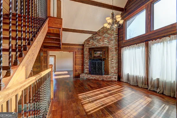 a kitchen with lot of cabinets and wooden floor