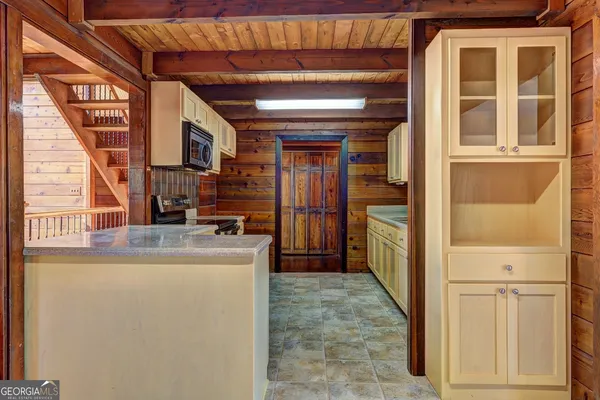 a view of a room with wooden floor and large window