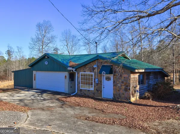 a view of a house with a yard and garage