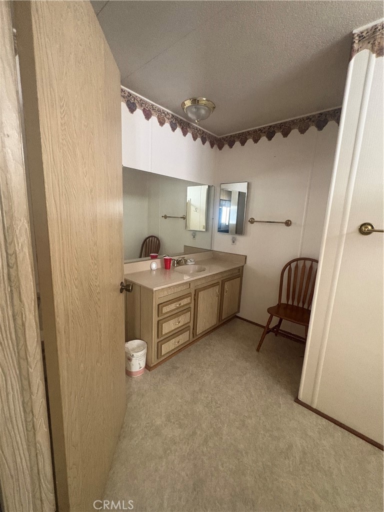 13393 Mariposa Road, Unit 114 Victorville, CA 92395 - Photo 13 of 18 a bedroom with a bed and a shower