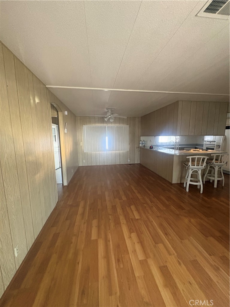 13393 Mariposa Road, Unit 114 Victorville, CA 92395 - Photo 6 of 18 wooden floor in an empty room with wooden floor