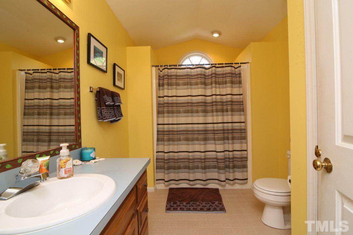1720 Park Ridge Way Raleigh, NC 27614 - Photo 14 of 25 a bathroom with a sink a toilet and shower