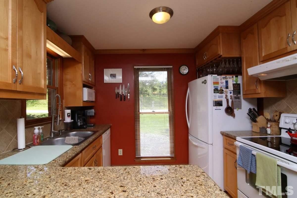 1720 Park Ridge Way Raleigh, NC 27614 - Photo 5 of 25 a kitchen with stainless steel appliances granite countertop a sink stove and refrigerator
