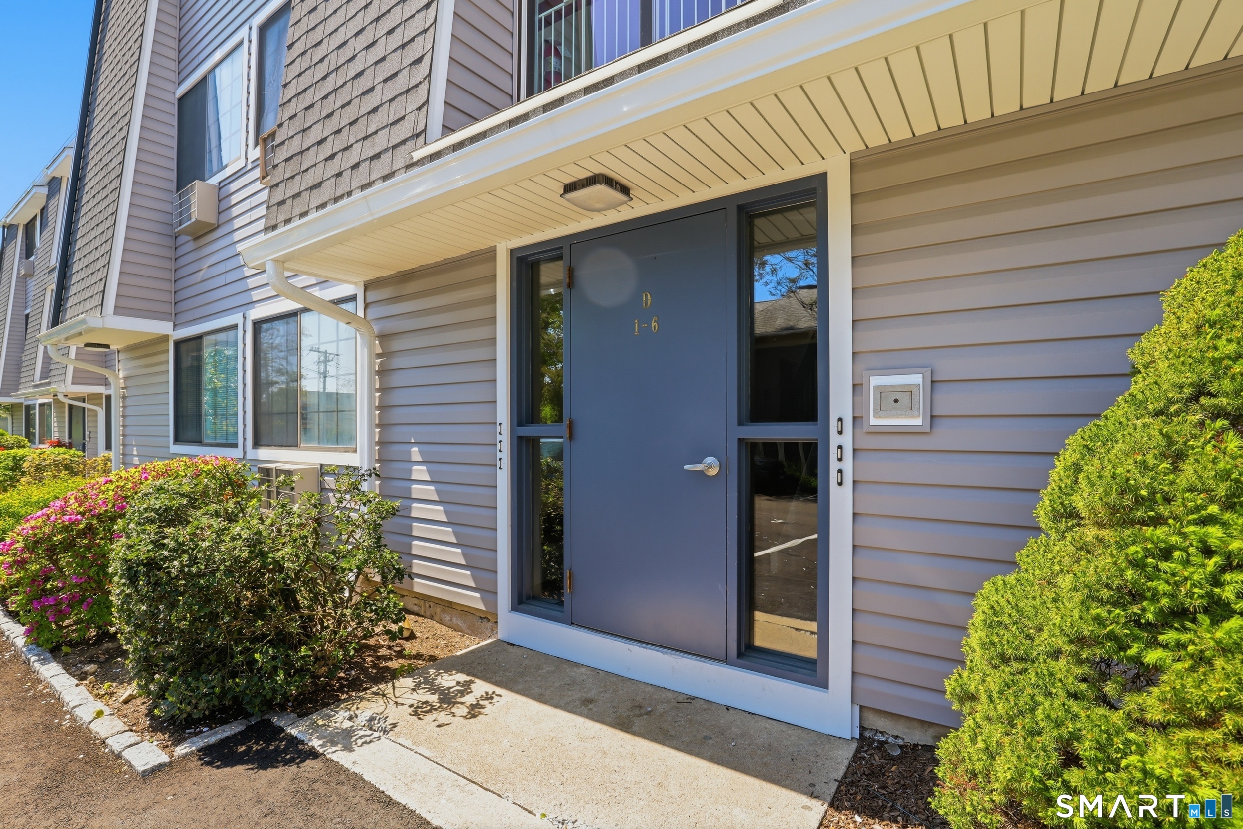 187 Flax Hill Road, Unit D1 Norwalk, CT 06854 - Photo 2 of 32 a front view of a house with a yard