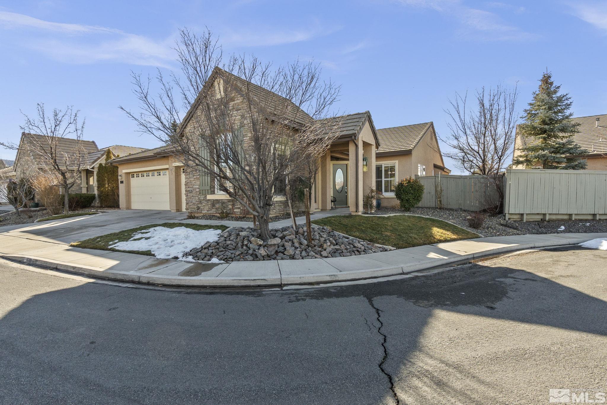 1646 Hearthstone Court Reno, NV 89521 - Photo 3 of 39 a view of a white house next to a yard
