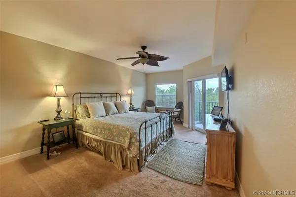 a bed room with a bed and a chandelier