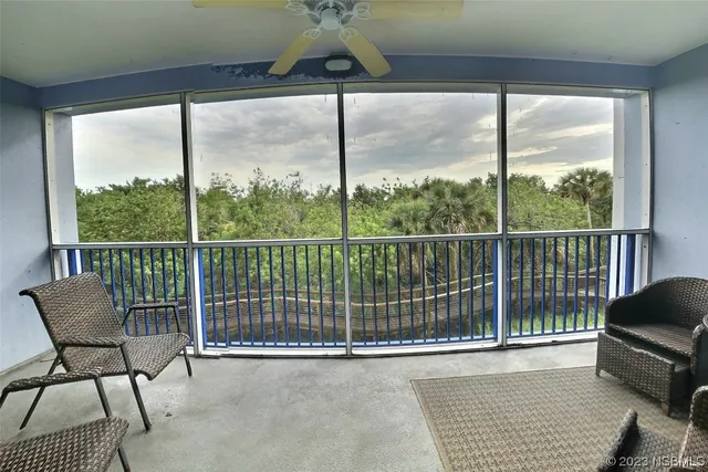 a view of a balcony with chair and table