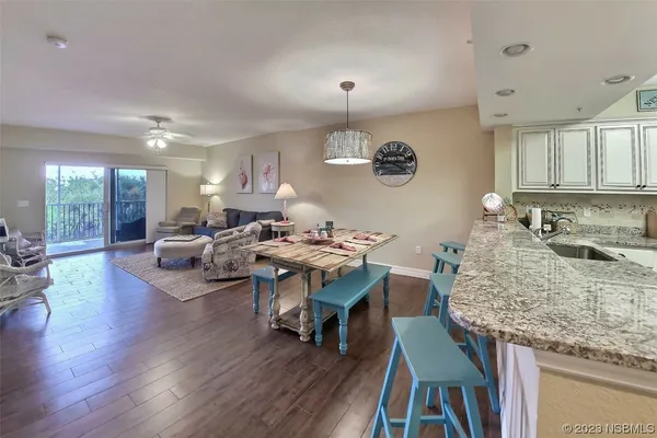 a living room with dining room and wooden floor