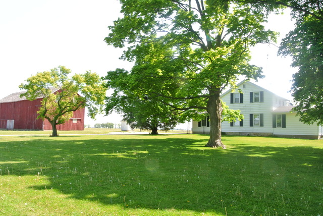 6388 Leland Road Waterman, IL 60556 - Photo 1 of 23 a front view of a house with a garden