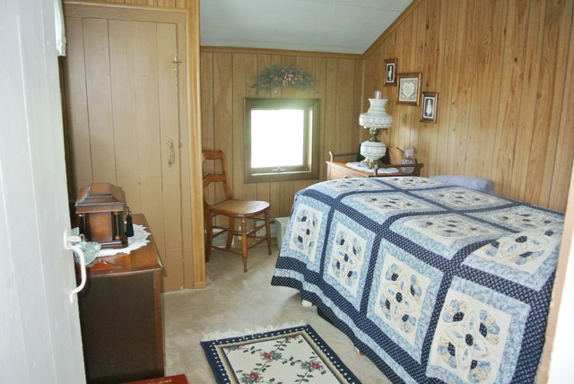 6388 Leland Road Waterman, IL 60556 - Photo 19 of 23 a bed room with a bed and a chair