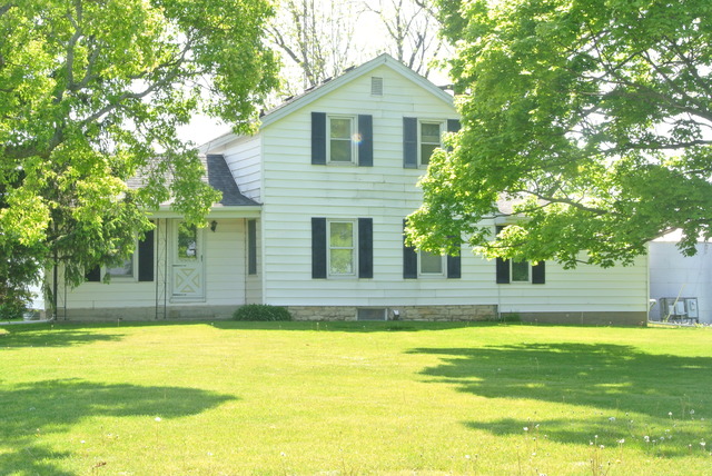 6388 Leland Road Waterman, IL 60556 - Photo 3 of 23 a front view of a house with a yard