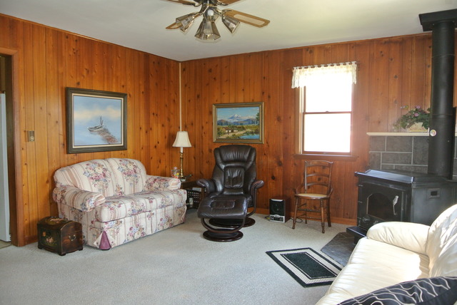 6388 Leland Road Waterman, IL 60556 - Photo 8 of 23 a living room with furniture a window and a chandelier