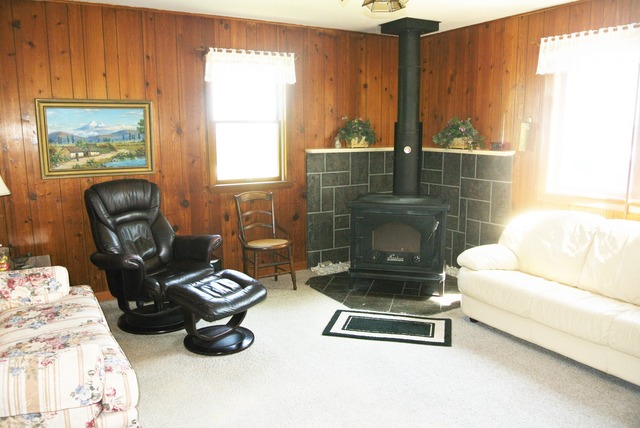 6388 Leland Road Waterman, IL 60556 - Photo 9 of 23 a living room with furniture a window and a fireplace