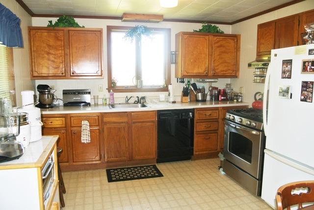 6388 Leland Road Waterman, IL 60556 - Photo 10 of 23 a kitchen with stainless steel appliances granite countertop a stove a sink dishwasher and a refrigerator