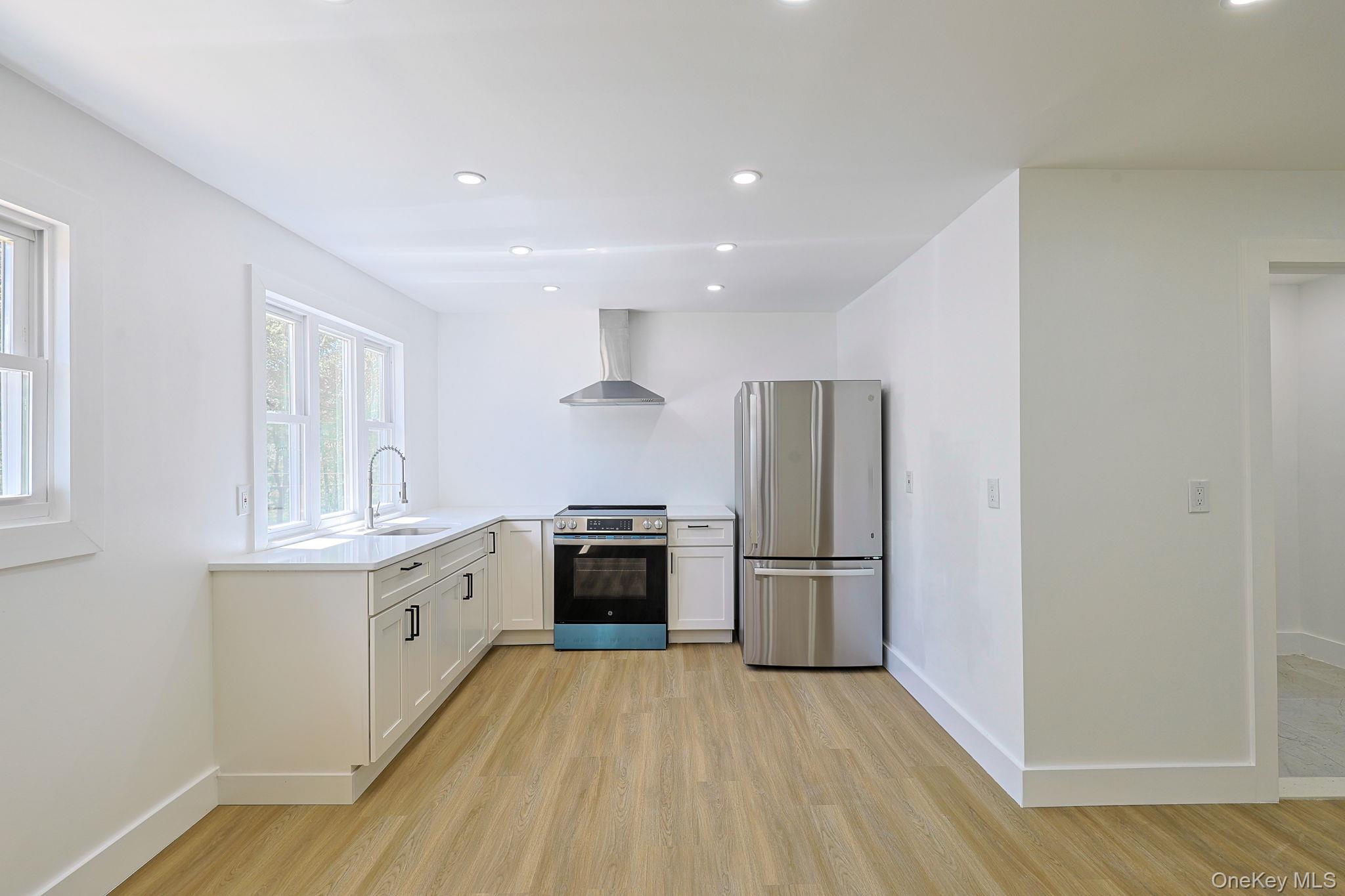 25 Overlook Road Woodbourne, NY 12788 - Photo 7 of 22 a kitchen with stainless steel appliances granite countertop a refrigerator a stove and a wooden floors