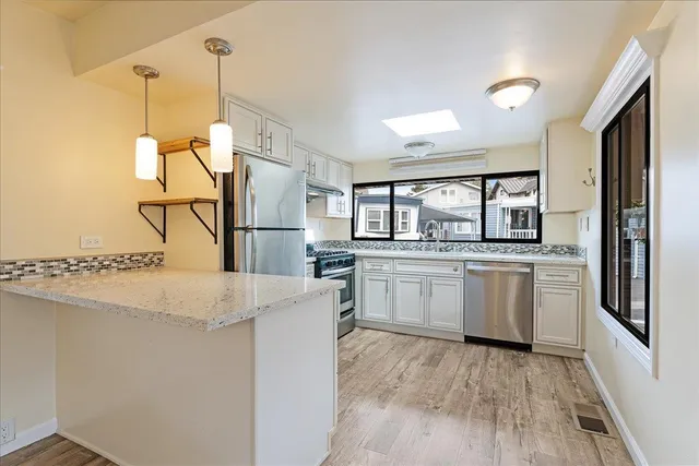 a kitchen with white cabinets and white appliances