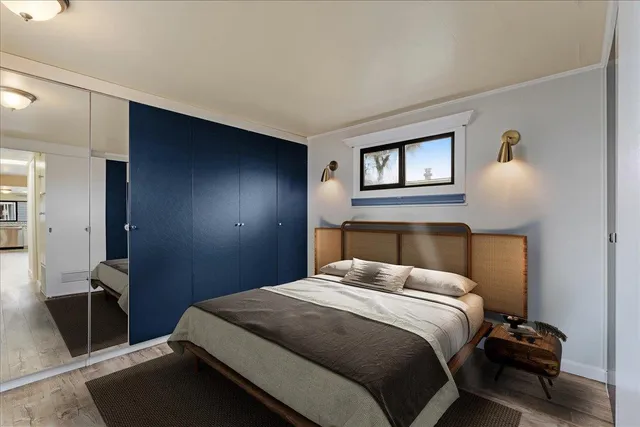 a bedroom with a bed and a night stand