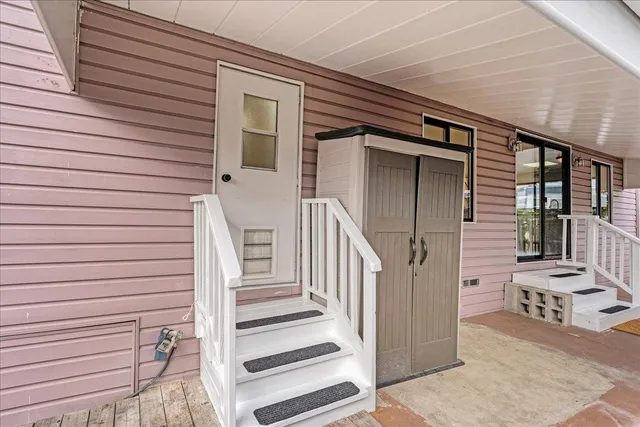 a view of a house with wooden stairs