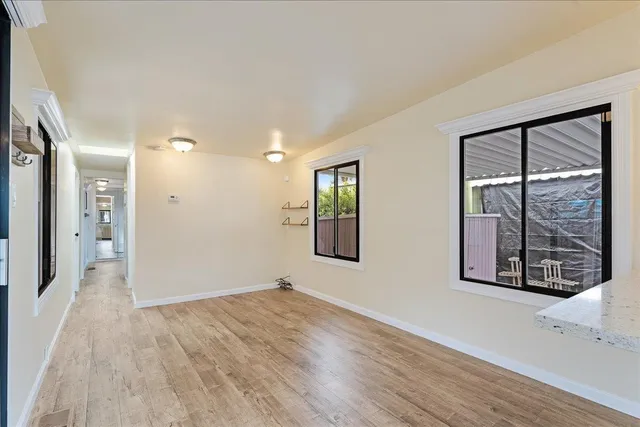 a view of an empty room with glass door