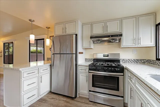 a kitchen with appliances and cabinets