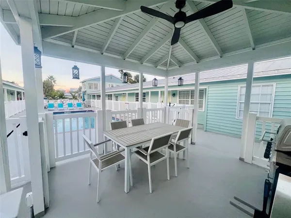 a dining room with a wooden table and chairs