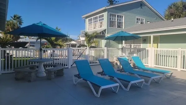 a view of a patio with a table and chairs