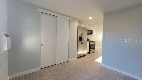 a view of a kitchen with a refrigerator and a sink