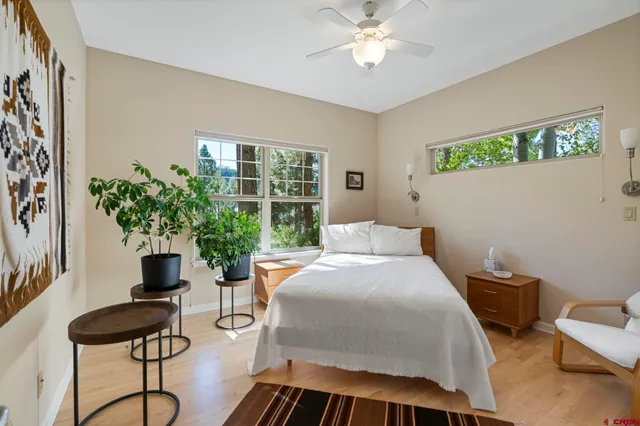 a bedroom with a bed and a potted plant