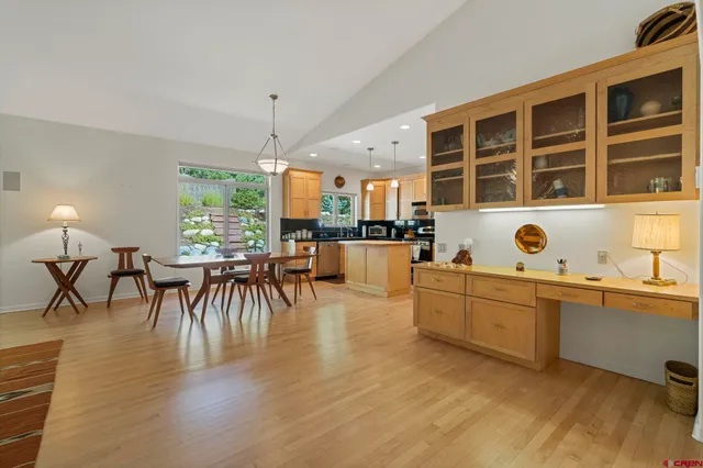 a large kitchen with a table and chairs in it