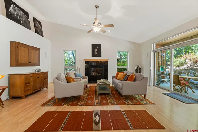 a living room with furniture fireplace and a window